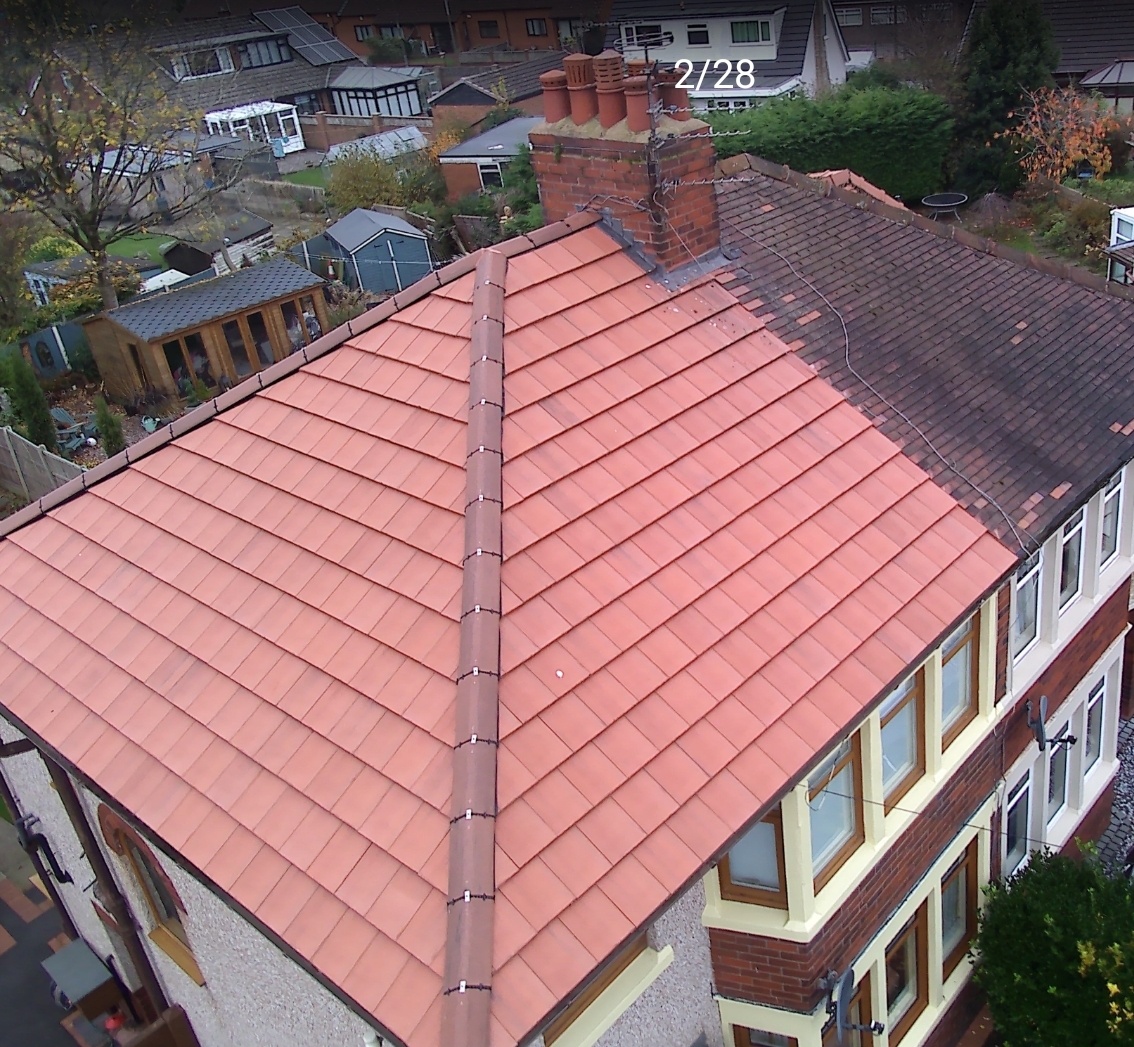 Aerial view of a new red tiled roof replacement next to an older neighbouring roof